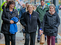 Mayor Mastraccio, Governor Mills, and others walkking and talking in downtown Sanford.